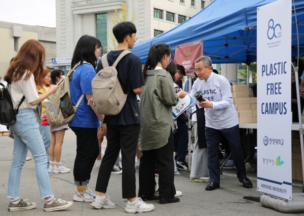 김우승 한양대 총장(오른쪽)이 25일 서울 성동구 서울캠퍼스에서 재학생에게 텀블러를 무상으로 나눠주며 텀블러 사용을 권장하고 있다. 한양대는 개교 80주년 가을축제(9.25~27)를 계기로 친환경 캠퍼스 조성을 위한 교내구성원의 적극적인 동참을 독려할 예정이다. (사진: 한양대 제공)