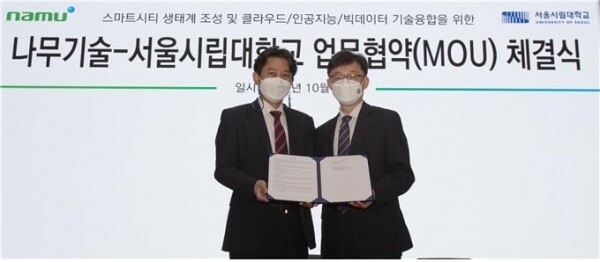 김홍준(왼쪽) 나무기술 상무와 염춘호 서울시립대 국제도시 및 인프라 연구센터장이 2021 대한민국 도시재생산업박람회에서 MOU를 체결하고 기념촬영 하고 있다. 사진=서울시립대 제공