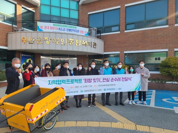 목포대 LINC+사업단과 무안지역자활센터 관계자들이 '희망잇기 어르신 안심 손수레 전달식'에서 파이팅을 외치고 있다. 사진=목포대 제공