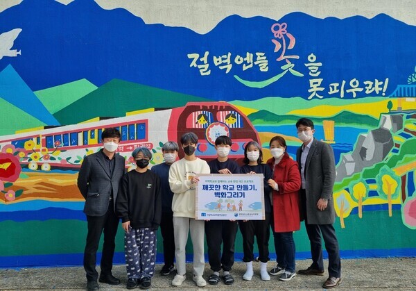 (왼쪽부터) 송흥수 사립학교교직원연금공단 관계자와 다시중학교 학생들이 벽화그리기를 진행한 뒤 기념촬영을 하고 있다. 사진=사학연금 제공