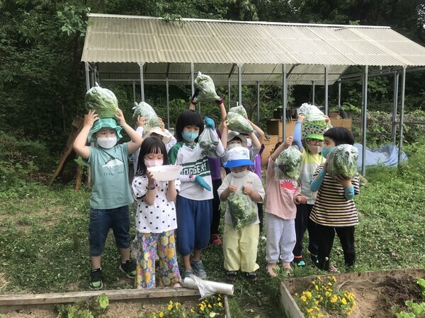 하늘땅 어린이집 아이들이 계원예술대가 제공한 텃밭에서 작물을 수확한 후 기념촬영을 하고 있다. 사진=계원예술대 제공
